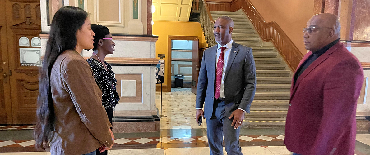 Two women greet two men in the Illinois Capitol
