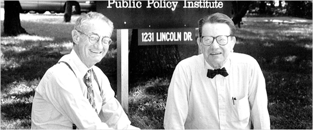 Mike Lawrence and Paul Simon pose in front of Public Policy Institute